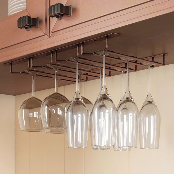 Stemware hangs from a rack mounted to a cabinet