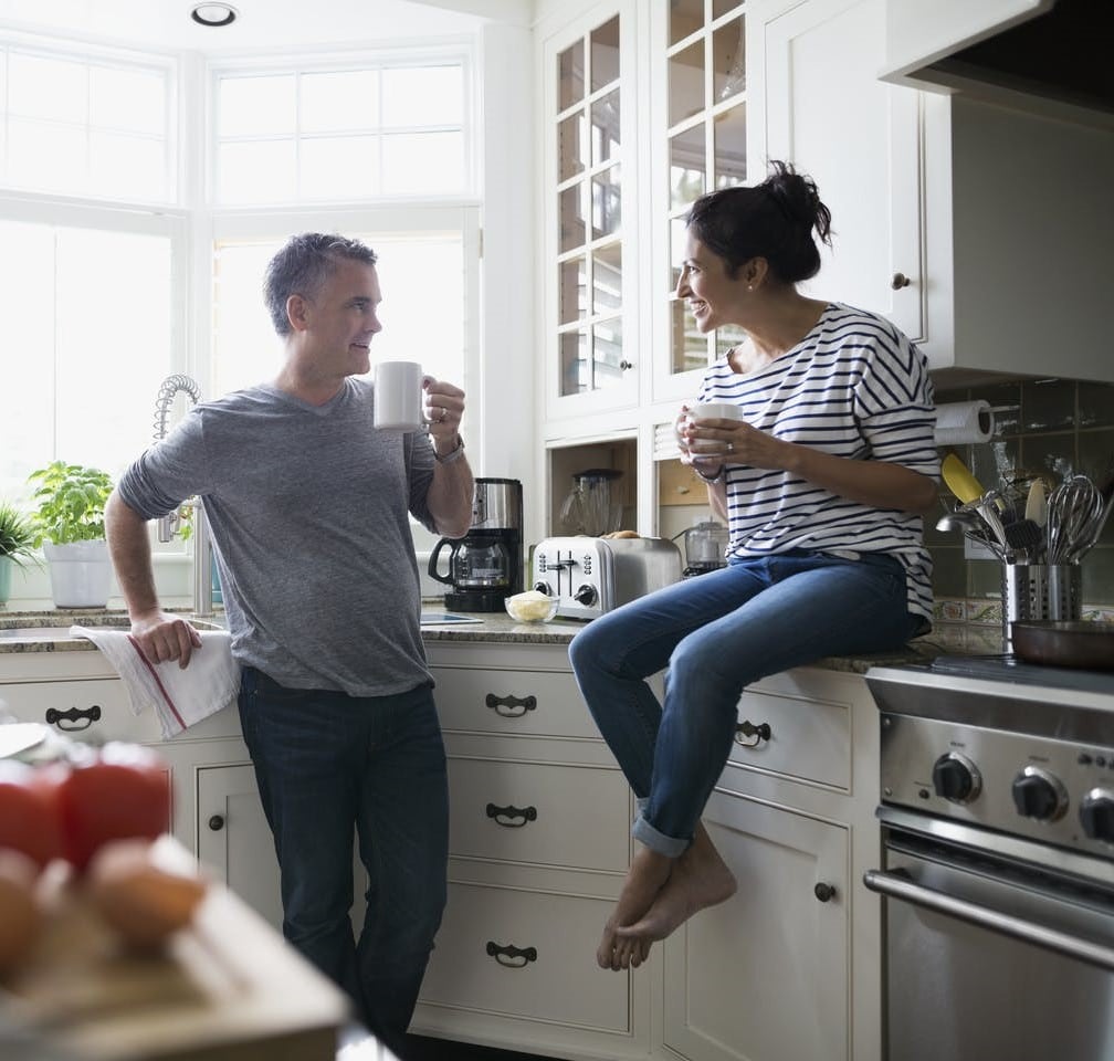 couple-enjoys-their-hard-work-repainted-kitchen-cabinets-during-remodel