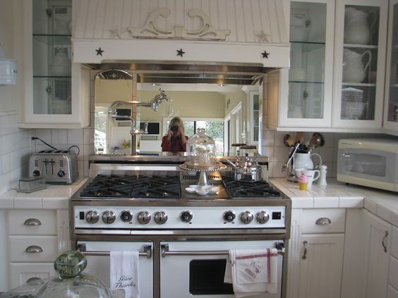 White Ironstone Cottage - mirror behind the stove