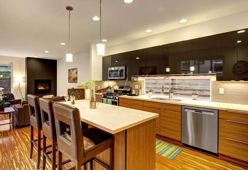 Contemporary kitchen with two tone cabinets with dark acrylic and light brown veneer and quartz island