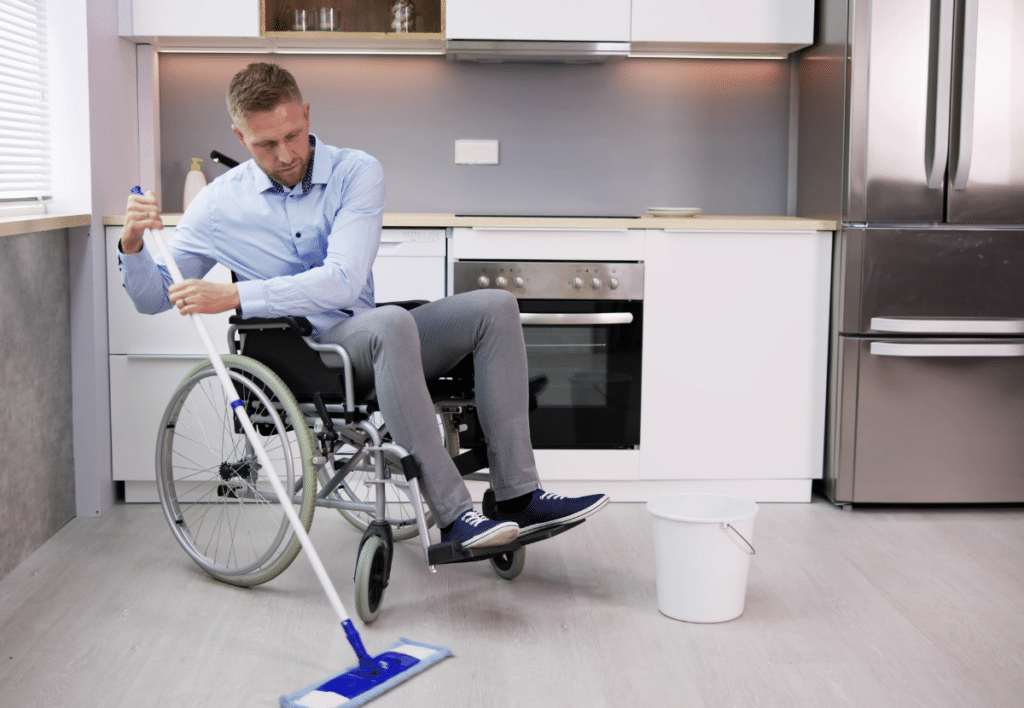 person with disability cleaning the kitchen floor